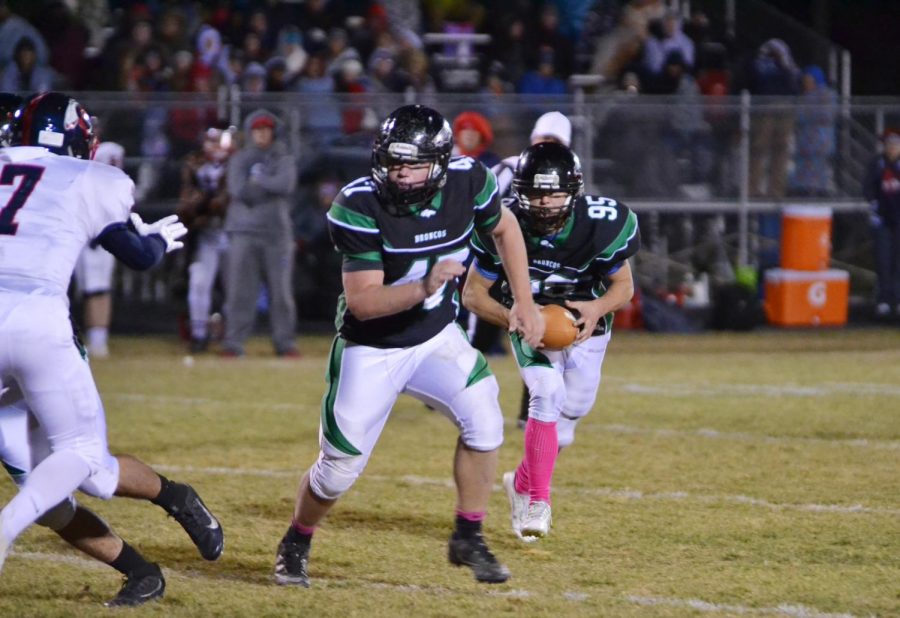 Cole Mays (12) protects the ball carrier Aric Vail (12).