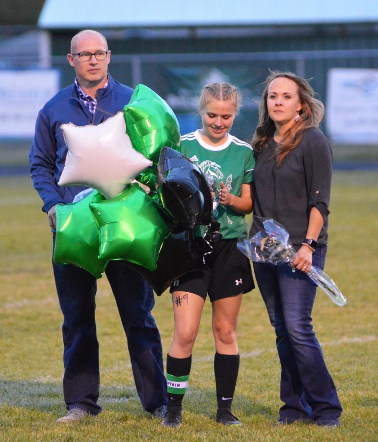 Kinsley Wray (12) being presented as she celebrates her last home game