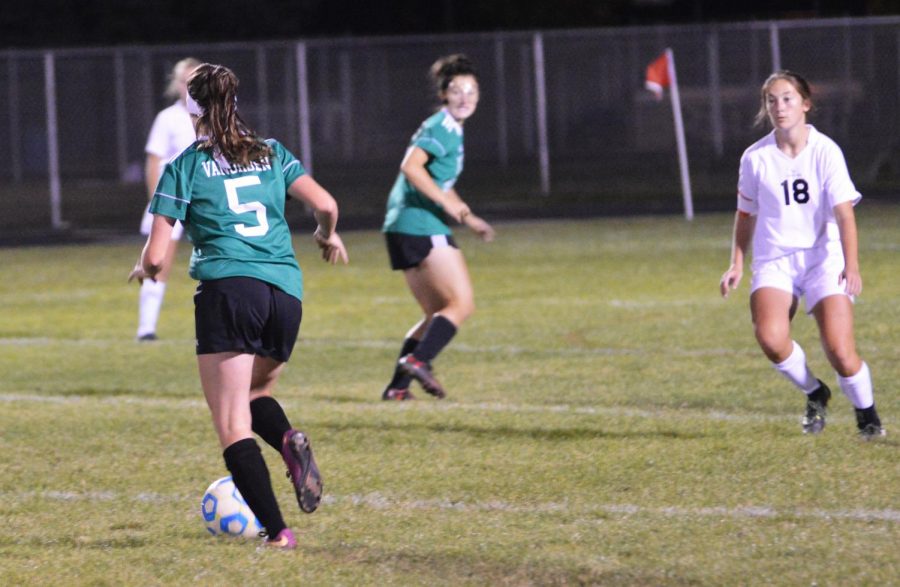 Abbie VanOrden (11) running down the ball before passing it to teammate