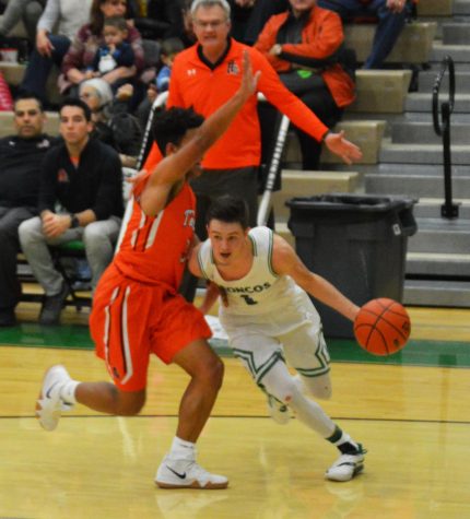 CHEEK TO CHEEK. Dexter Hale (12) pushes by a defender