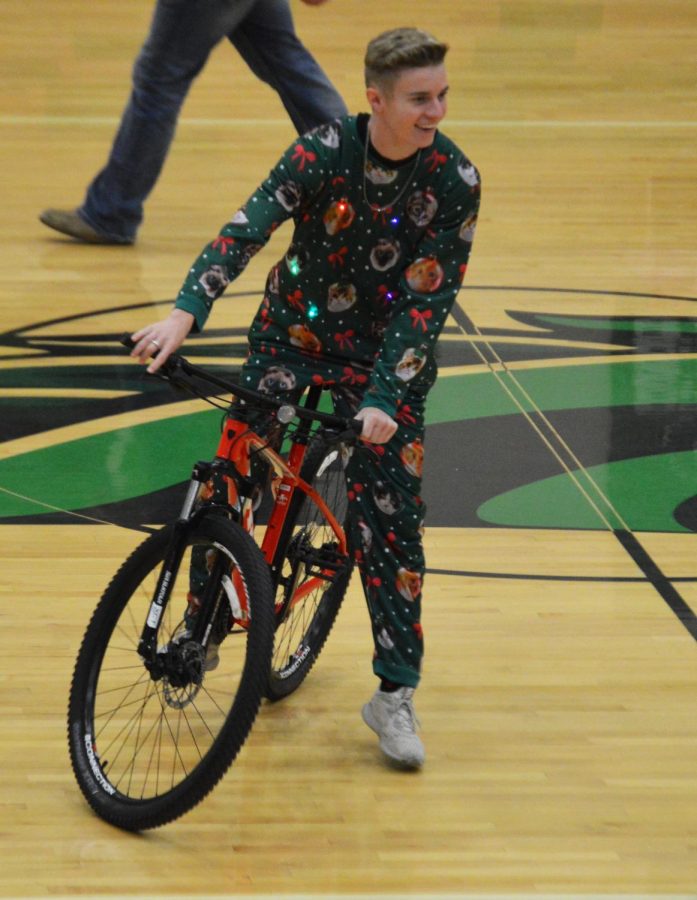 Nephi Bigler (12) showing off a bike that was auctioned off.