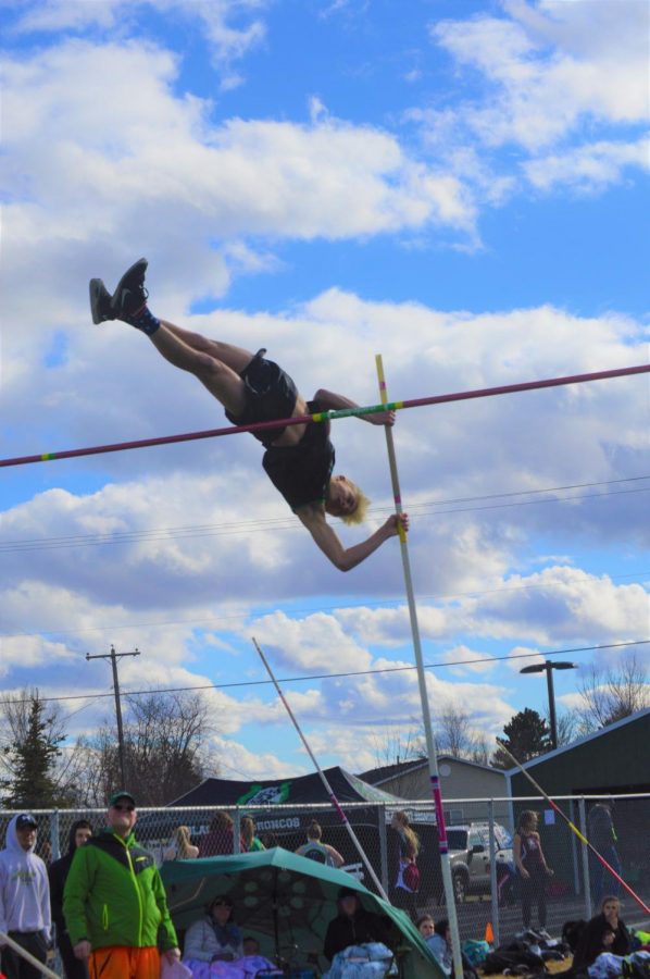 KEEP CLIMBING. Landon Abercrombie [12] shoots up from the ground and over the bar with his pole