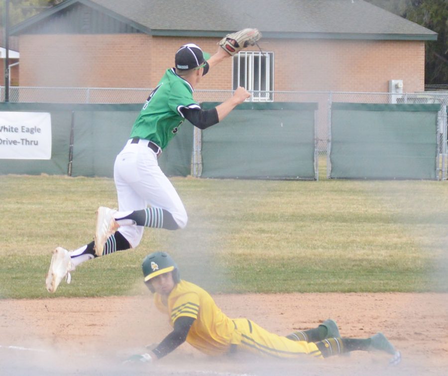 JUMP OF GLORY. Carter Cooper jumps high over Bonneville Bee to catch the ball at third.