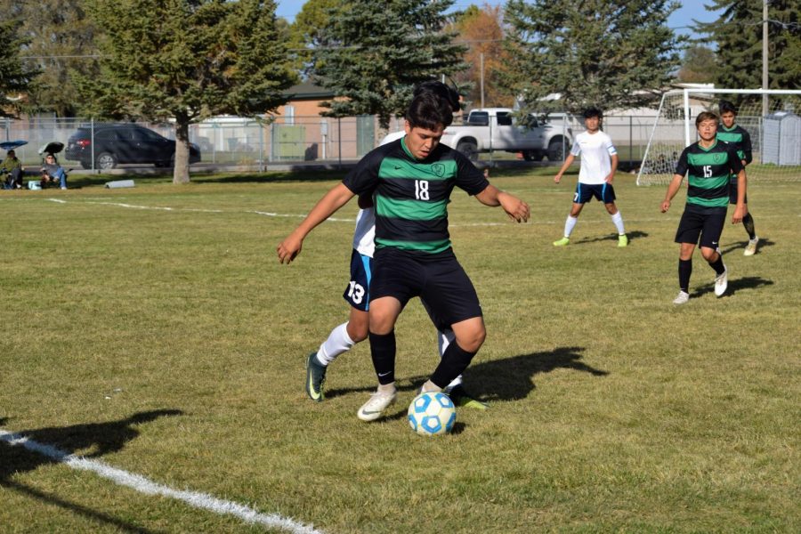 To keep the ball on our offensive half of the field, senior Ivan Zamora shields and contains the ball. 