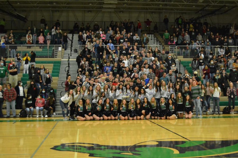 Cheerleaders and Girls Basketball pose for a picture with the student body